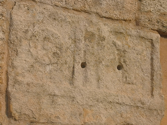 Bassorilievo inciso con simboli pagani