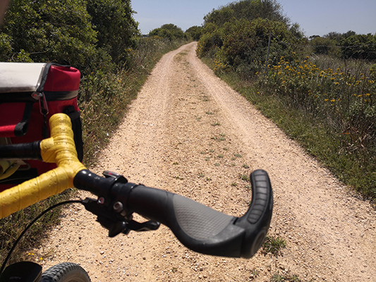 Strada bianca con manubrio della bicicletta